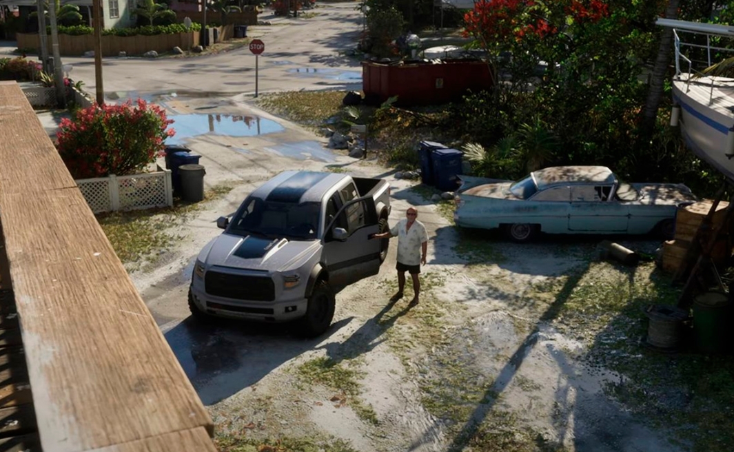 Житель Леониды стоит рядом с пикапом в жилом районе из второго трейлера GTA VI